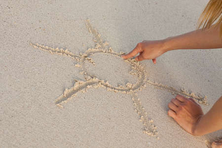 hand writing in sand in summer holiday vacation on beach の写真素材