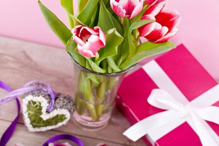 pink and white tulips present ribbon easter birthday symbol festiveの写真素材