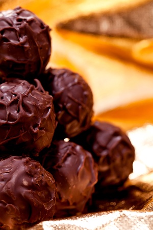 collection of different chocolate pralines truffels on golden brown background macroの写真素材