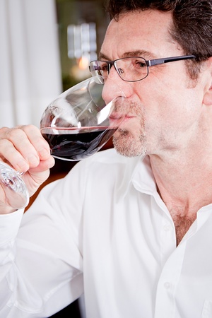 man and woman in restaurant for dinner drinking red wine and smilingの写真素材