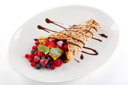 fresh tasty homemade crepe pancake with chocolate sauce fruits and berriesの写真素材