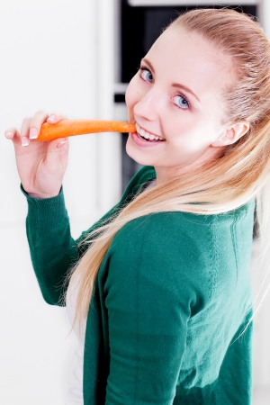 young woman cooking vegetarian food in kitchenの写真素材