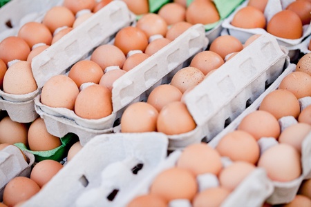 group of brown eggs in carton box closeup market outdoorの写真素材