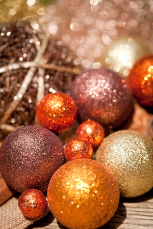 glittering christmas decoration in orange and brown natural wood closeup macroの写真素材