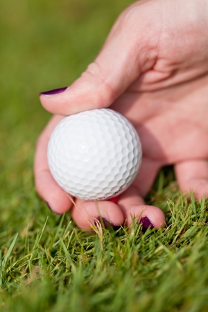 golf ball and iron on green grass detail macro summer outdoor playing golf の写真素材