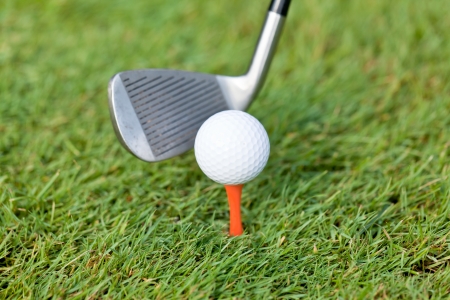 golf ball and iron on green grass detail macro summer outdoor playing golf の写真素材