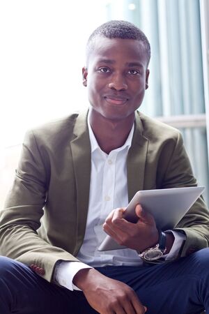 smiling successful businessman with tablet pc outdoor in summer の写真素材