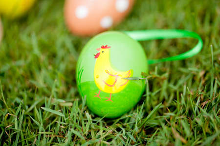 colored easter eggs group in green grass outdoor in spring macro closeupの写真素材