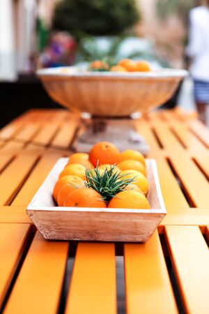 fresh colorful orange fruits decorative on table in summer outdoorの写真素材