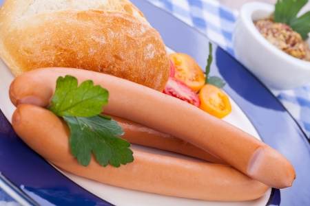 tasty sausages frankfurter with grain bread  on tableの写真素材