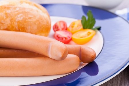 tasty sausages frankfurter with grain bread  on tableの写真素材