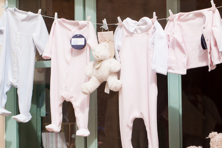 baby clothing and teddy bear in window shopping objectsの写真素材