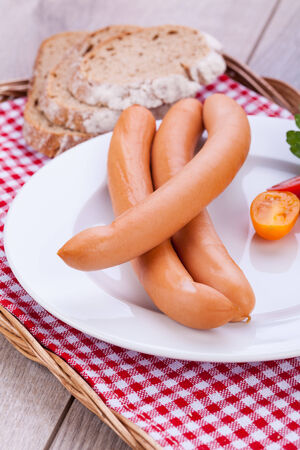 tasty sausages frankfurter with grain bread  on tableの写真素材