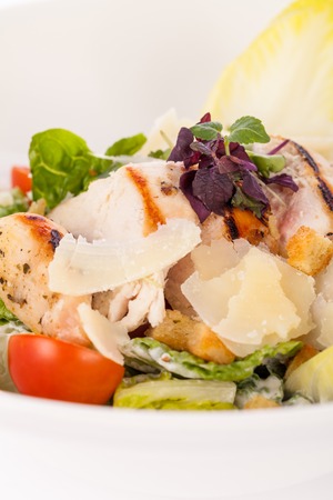 tasty fresh caesar salad with grilled chicken parmesan and croutonsの写真素材