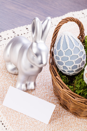 Easter still life with a metallic silver bunny ornament and eggs handpainted with colourful polka dot patterns for your seasonal greetingの写真素材
