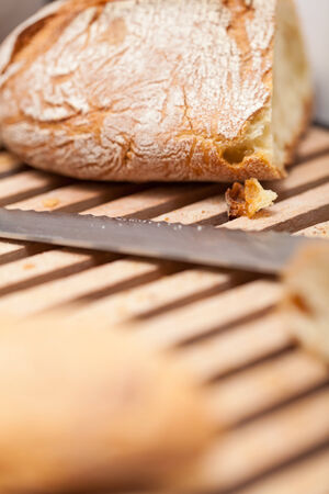 homemade fresh baked bread and knife on wooden table