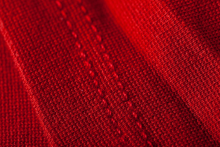 Abstract background texture of luxurious red fabric arranged in sensual soft folds with highlight and shadowの写真素材