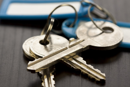 Macro Shot of Conceptual House Keys on Top of Wooden Tableの写真素材