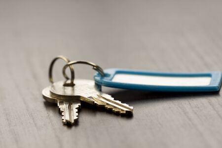 Macro Shot of Conceptual House Keys on Top of Wooden Tableの写真素材