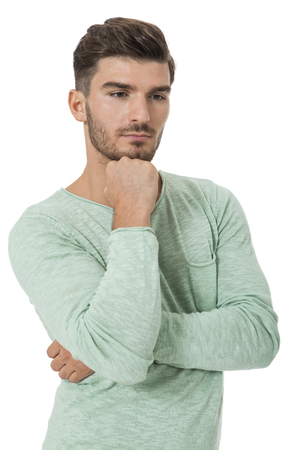 Puzzled handsome young man scratching his head with his hand as he looks at the camera with an uncertain perturbed expression, isolated on whiteの写真素材