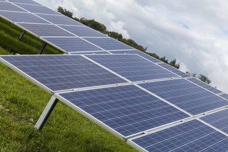 Field with blue siliciom solar cells alternative energy to collect sun energyの写真素材