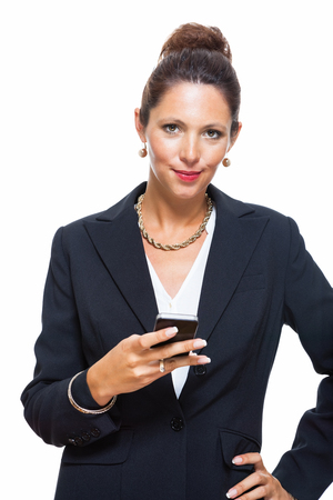 Portrait of a Happy Young Businesswoman Wearing Black Suit, Calling Someone on Mobile Phone. Isolated on White Background.の写真素材