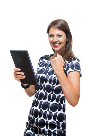 Portrait of a Smiling Lady in an Elegant Printed Dress Holding a Tablet Computer with Copy Space While Looking at the Camera. Isolated on White Background.の写真素材