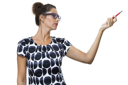 Portrait of Serious Woman with Eyeglasses, Wearing a Printed Dress, Holding a Red Ballpoint Pen. Captured in Studio with White Background.の写真素材
