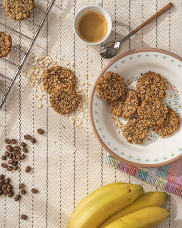 freshly baked oat cookies with bananas, espresso coffee and coffee beans.の写真素材