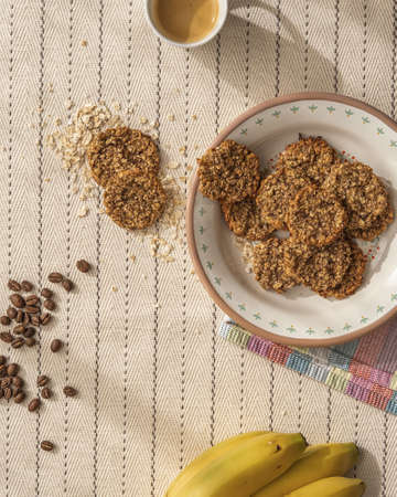 Enamel plate with fresh baked oat cookies with coffee beans.の写真素材