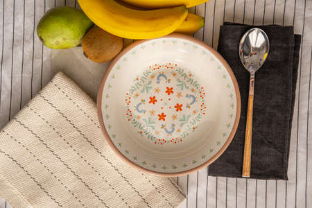 enamel plate with drawings, on a table with fruits.の写真素材