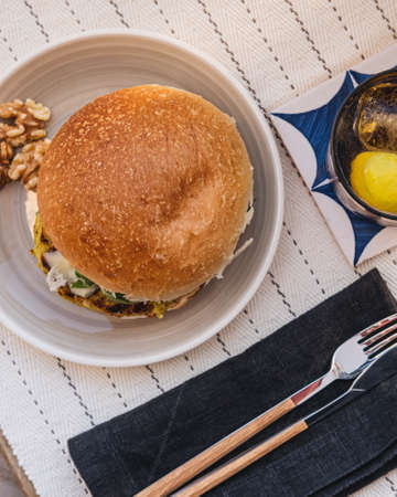Veggie burger on a table in a top view. with a tonic water a side.の写真素材