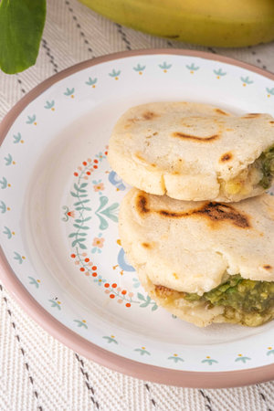 Venezuelan Arepas filled with cheese, bananas and avocado.の写真素材