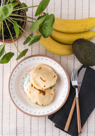 Venezuelan Arepas filled with cheese, bananas and avocado.の写真素材
