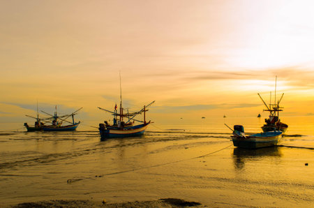 Fishing Boat at Sunrise, on seaの写真素材