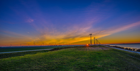 Sunrise over field, electric turbines. Sunriseの写真素材
