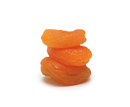 Pile of dried pitted and halved apricot, isolated on white backgroundの写真素材