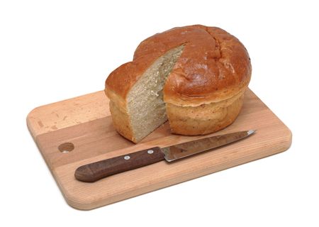 Loaf of sliced bread on a wooden cutting board with a knife, isolated on a white backgroundの写真素材