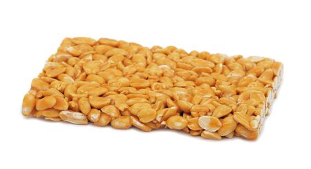 Peanut brittle, isolated on a white backgroundの写真素材