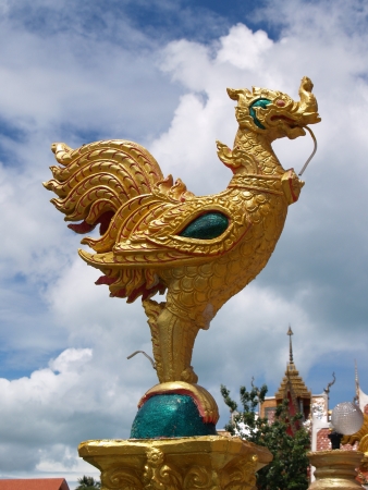 Thailand religious gold cock on the blue sky backgroundの写真素材