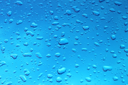 Rainy drops on the blue sky backgroundの写真素材