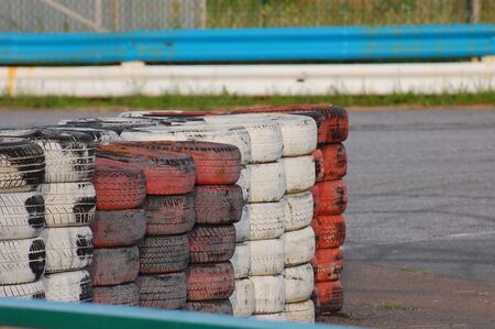 Red and white old tyres on the racing trackの写真素材
