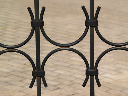 A part of black forged metal fence on the streetの写真素材