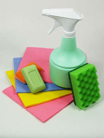 Orange and green soap with light green sprayer and wisp on the colored napkinの写真素材