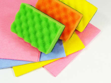 Green, orange and yellow sponges on the colored napkinsの写真素材