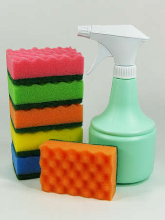 Colored sponges with light green sprayer, close upの写真素材