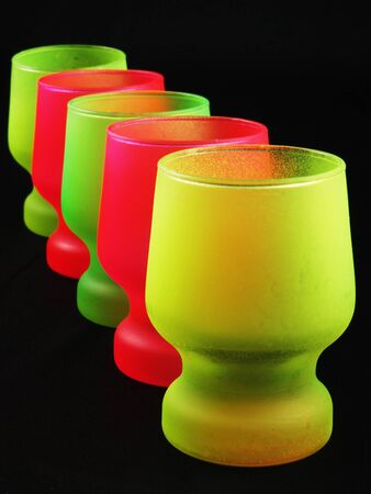 Colorful shot glasses on the black backgroundの写真素材