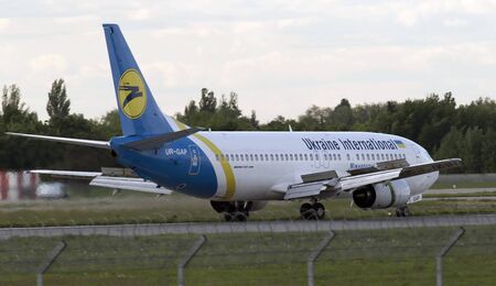 Borispol, Ukraine - May 6, 2014 Ukraine International Airlines Boeing 737-400 aircraft landing on the runway of Borispol International Airport on May 6, 2014. Editorial use onlyのeditorial素材