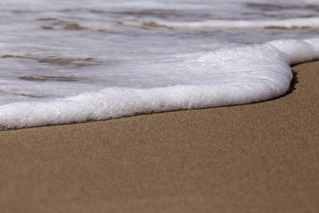 Sea waves on tropical beach in summer dayの写真素材