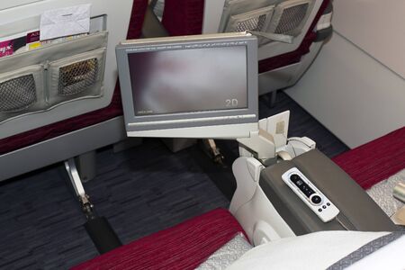 Borispol, Ukraine - August 28, 2017: Qatar Airways Airbus A320 business class seats with entertainment system onboard. Editorial use onlyのeditorial素材